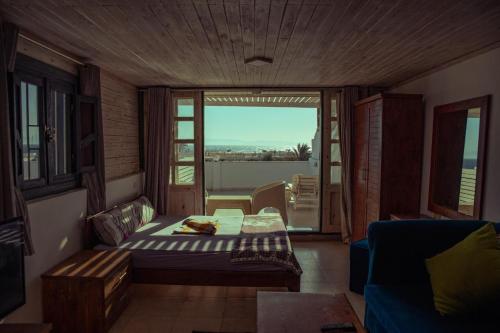 a room with a couch and a table and a window at Station House in Dahab