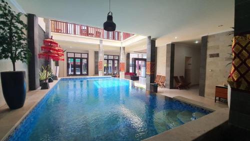 a large swimming pool in the middle of a house at Grand Puri Hotel in Nusa Penida