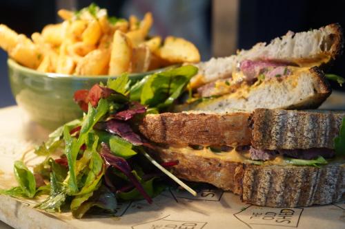 a sandwich and french fries and a bowl of food at Banbury Hill Farm Bed & Breakfast in Charlbury