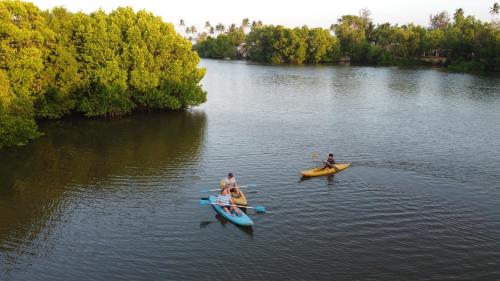 a group of people in kayaks on a river at Marakolliya Beach Resort in Tangalle