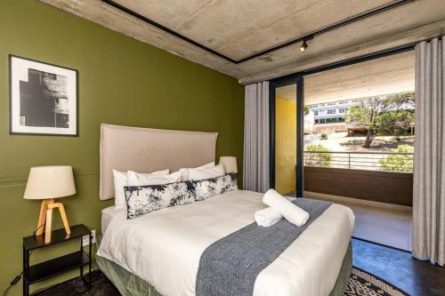 A bed or beds in a room at Group travel in the heart of CT Heritage suburb!