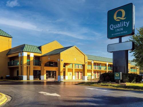 a large building with a sign on the side of it at Quality Inn Fort Campbell in Oak Grove