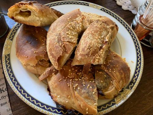 a plate of pastries on a wooden table at Hotel Papanikola in Piána