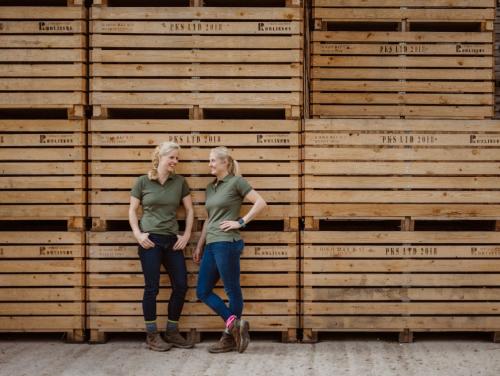 two women standing in front of a stack of wooden pallets at The Old Granary in Barnetby le Wold