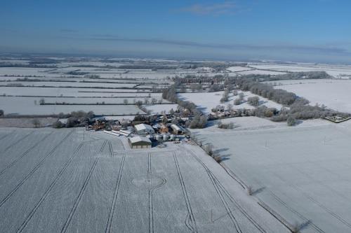 an aerial view of a large field with snow at The Old Granary in Barnetby le Wold