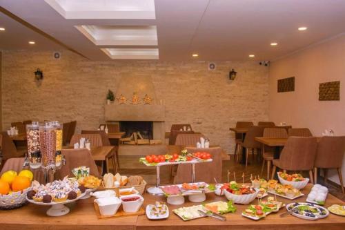 a table with a bunch of food on it at Hotel King David Bakuriani in Bakuriani