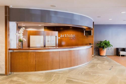 an office lobby with an entourage sign on the wall at Acta Arthotel in Andorra la Vella