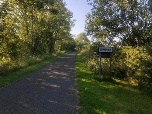 a dirt road with a sign that says outreach at The Old Granary in Barnetby le Wold
