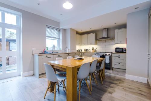 a kitchen with a wooden table and chairs at Cromwell House in Chester