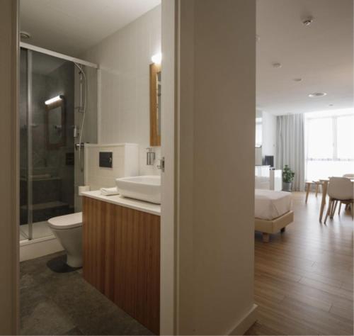 塞維利亞的住宿－MUSH ROOM APARTAMENTOS，浴室配有卫生间、盥洗盆和浴缸。