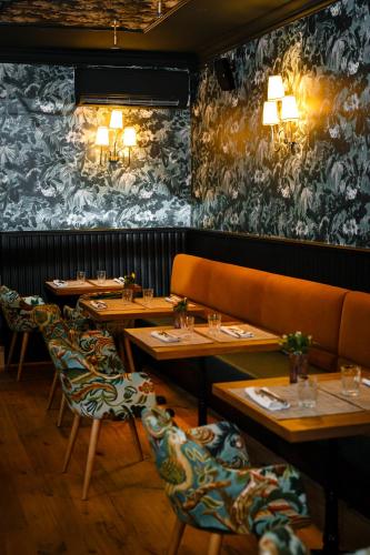 a row of tables in a restaurant with lights on the wall at Hotel Born in Palma de Mallorca