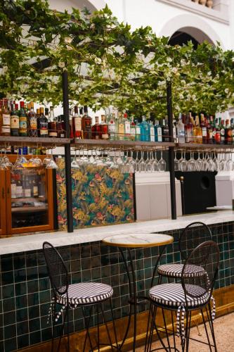 two chairs and a table in front of a counter at Hotel Born in Palma de Mallorca