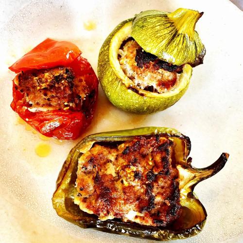 a white plate with two stuffed peppers on it at La Maison du Passage - Chambres - Suites premium, Spa, Piscine et Restaurant in Martignargues