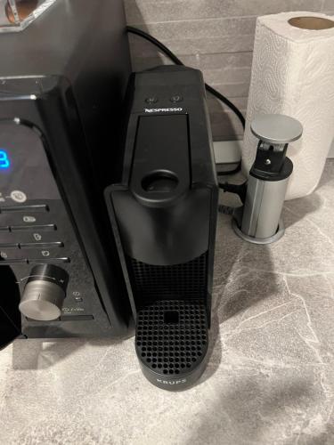 a black computer monitor sitting on top of a table at Cozy Penthousestudio Cityview W12 in Bucharest