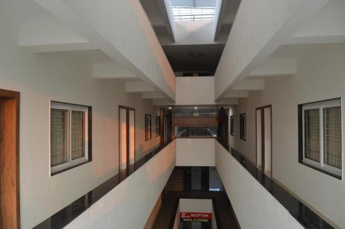 a hallway in a building with a skylight at Hotel Revive in Veraval