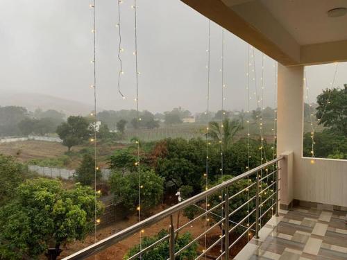 a balcony with a view of a field and trees at Private Room Non AC At Varun Vihar Near Horsley Hills in Kurabalakota