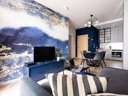 a living room with a large painting on the wall at Kolejowa ApartHotel in Warsaw