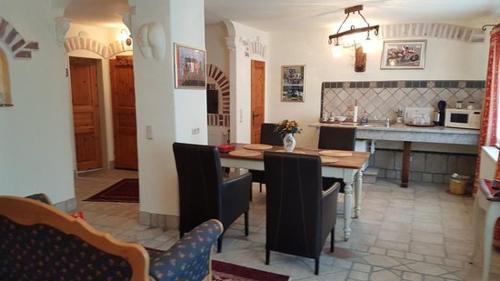 a kitchen and dining room with a table and chairs at Domizil Hotel Düren "Kastanienhof" in Düren - Eifel