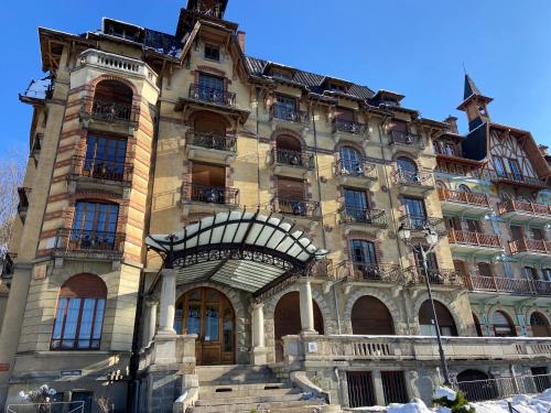 a large stone building with a staircase in front of it at Elegant historic apartment Le Mont Joly - 3 bed 2bath view 80m2 in Saint-Gervais-les-Bains