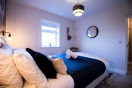 a bedroom with a bed with pillows and a window at Cannon Cottage in St John's Point