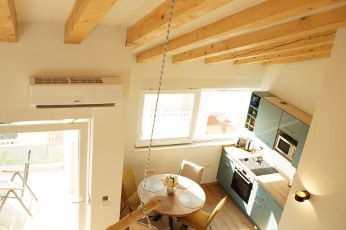 a small kitchen with a table and a dining room at HvarLove Seaview Luxury in Hvar