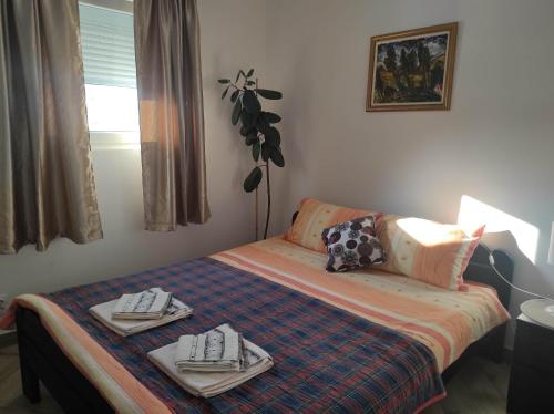 a room with a bed with two plates on it at Andrea Airport Apartments in Belgrade