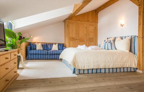 a bedroom with a bed and a blue couch at Winterstellgut in Annaberg im Lammertal