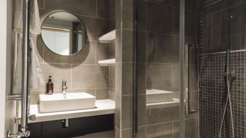 a bathroom with a sink and a mirror at Apex2100 International Ski Academy Tignes in Tignes