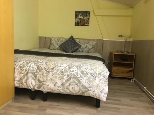 a bedroom with a bed with a white comforter at PensionLien in Köthen