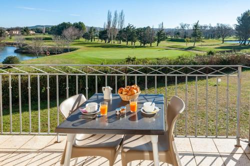 a table with a bowl of food on a balcony at Residhotel Golf Grand Avignon in Vedène