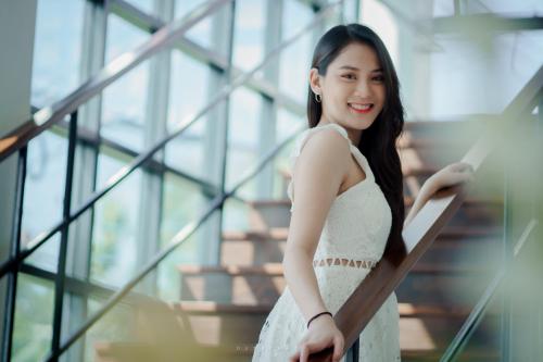 a woman in a white dress standing on a staircase at Play Poshtel & Cafe' in Krabi town