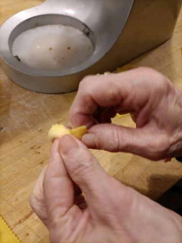 a person cutting a piece of food on a cutting board at Hotel Cristallo in Riccione