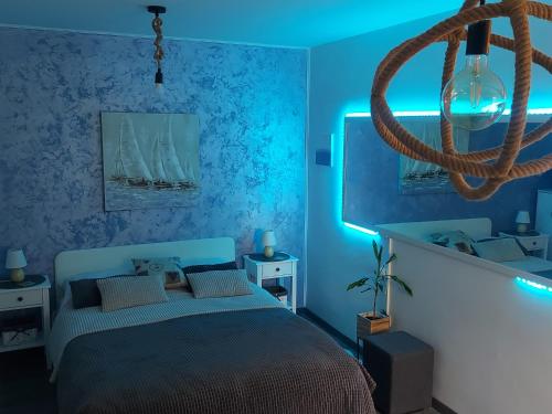a bedroom with a bed with a blue light at Apartment Melody in Dubrovnik