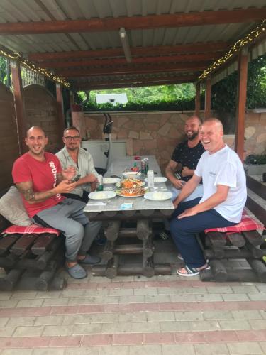 a group of men sitting around a picnic table at PensionLien in Köthen