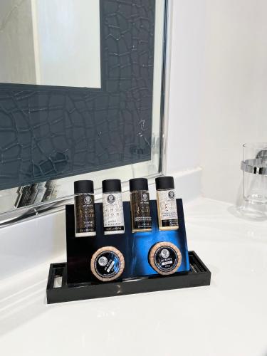 a group of four cell phones sitting on a bathroom counter at Theoxenia House Hotel in Athens