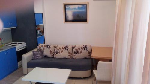 a small living room with a couch and a table at Apartments Vozdovac in Belgrade