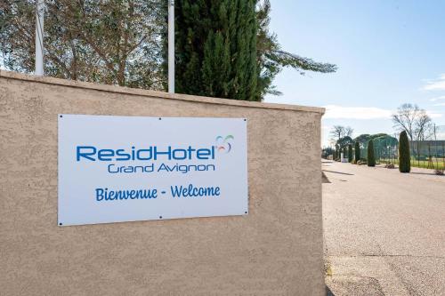 a sign on a wall next to a street at Residhotel Golf Grand Avignon in Vedène
