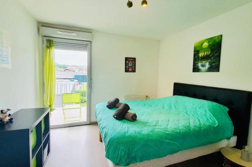 une chambre avec un lit avec un ours en peluche dessus dans l'établissement Les Hauteurs d'Annecy 2 étoiles entre lac et montagne, à Annecy