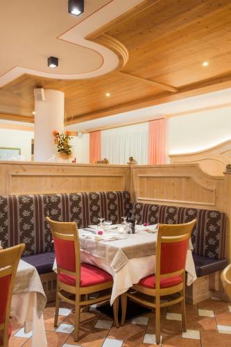 a dining room with a table and chairs at Hotel Stella Alpina in Andalo