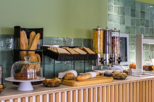 a buffet with bread and pastries on a counter at Best Western Plus Ajaccio Amirauté in Ajaccio
