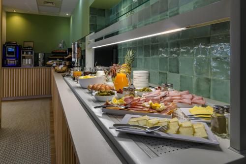 a buffet line with appetizers and meats and cheese at Best Western Plus Ajaccio Amirauté in Ajaccio