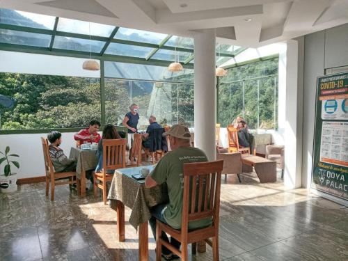 un groupe de personnes assises à une table dans un restaurant dans l'établissement Hotel Qoya Palace - Machupicchu, à Machu Picchu