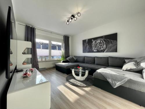 a living room with a couch and a table at - Top Ausstattung - Kostenlos Netflix/Wifi/Parken in Gladbeck