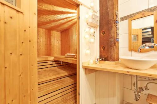a sauna with a sink and a mirror at Landhaus Kurzenmoor - Tenne (410 qm) in Seester