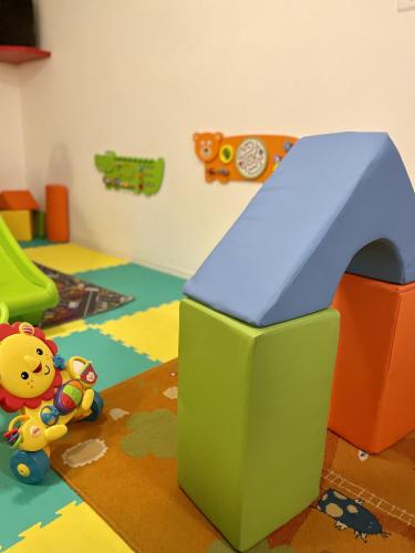 a childs play room with a toy play set at Hotel Stella Alpina in Andalo