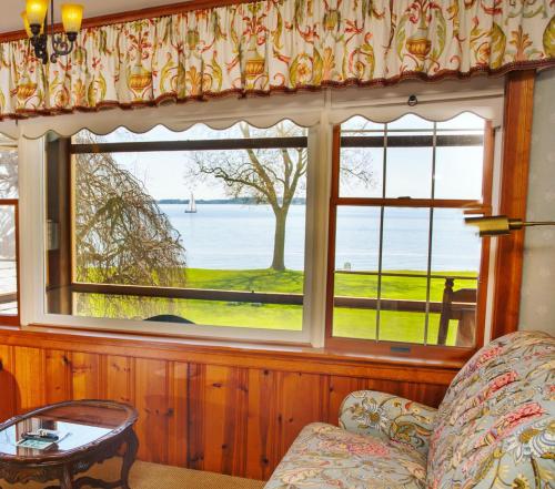 a living room with a couch and a window at Sandaway Suites & Beach in Oxford