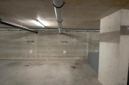 an empty parking garage with numbers on the wall at Albert-INN-Glowe - barrierefrei & 3 Schlafzimmer & Coworking & Strandkorb-saisonal & Sauna im Haus & Fahrräder in Glowe
