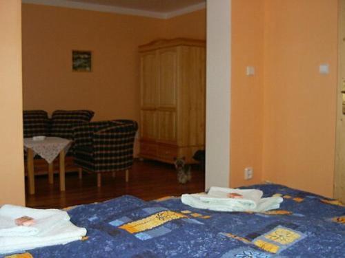 a bedroom with a bed with towels on it at Penzion Olga in Mariánské Lázně