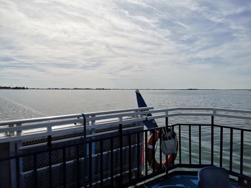 a boat on a body of water with a railing at Le Nichoir Lac du Der in Droyes