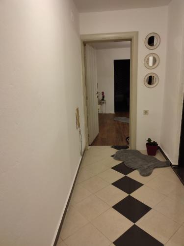 a hallway with a black and white checkered floor at V&J apartments in Podgorica